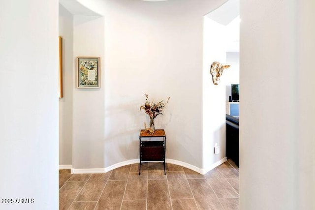 hallway featuring baseboards