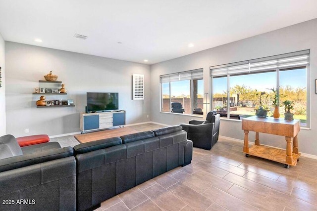 living room featuring recessed lighting, visible vents, and baseboards