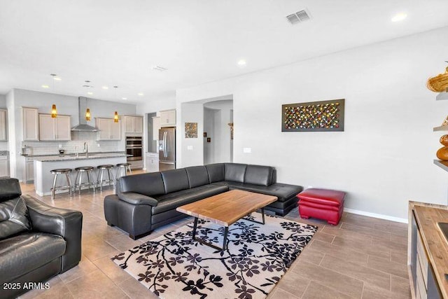 living area with light tile patterned flooring, baseboards, visible vents, and recessed lighting