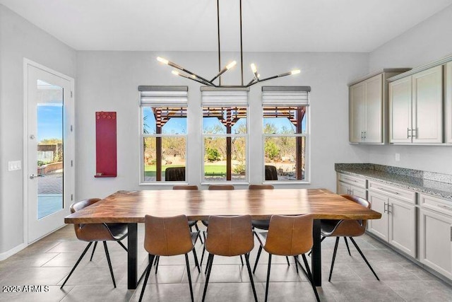 dining room with light tile patterned floors and a notable chandelier