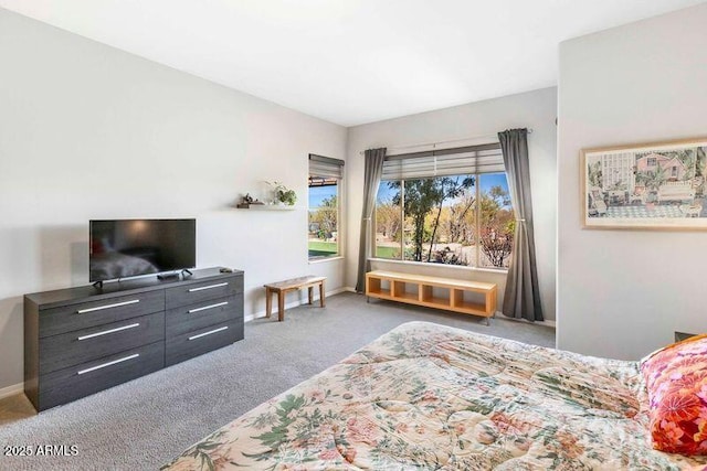 bedroom featuring light carpet and baseboards