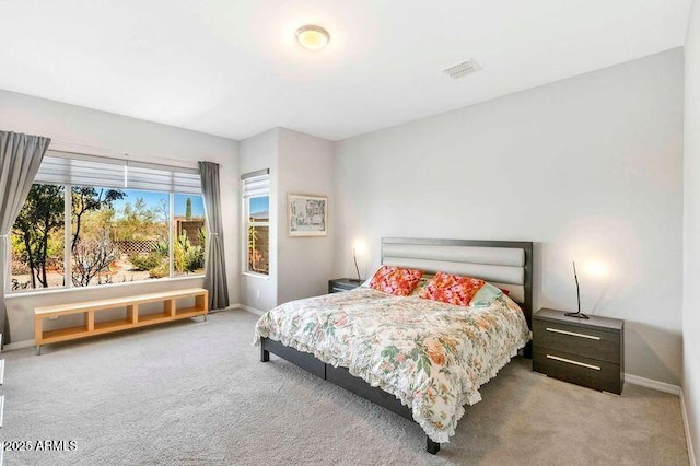 carpeted bedroom featuring visible vents and baseboards