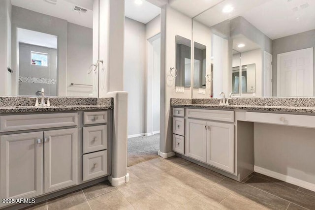 full bath featuring tile patterned flooring, visible vents, vanity, and baseboards