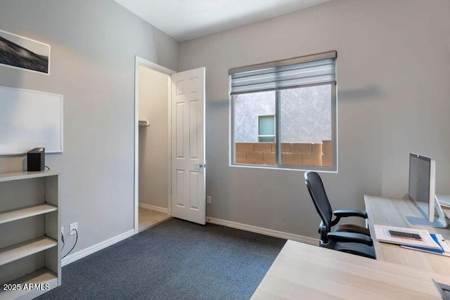 office space featuring dark carpet and baseboards