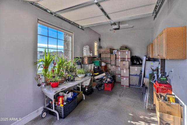 garage with baseboards and a garage door opener