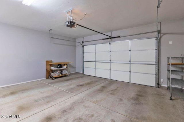 garage with a garage door opener and baseboards