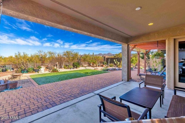 view of patio / terrace featuring a fenced backyard and a mountain view