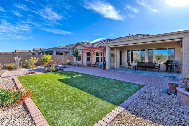 rear view of property featuring a patio, a lawn, fence private yard, and stucco siding