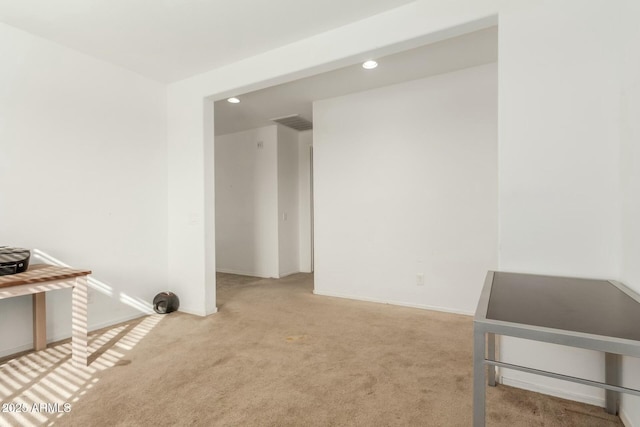 unfurnished living room featuring light carpet