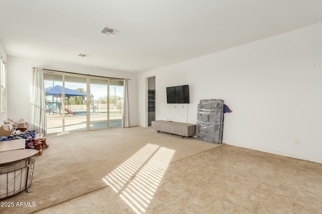 sitting room featuring light colored carpet