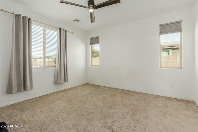 unfurnished room with ceiling fan and carpet floors