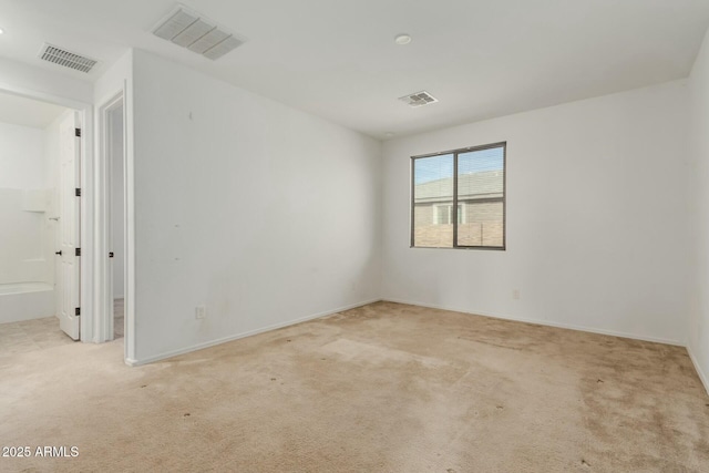 unfurnished room featuring light colored carpet