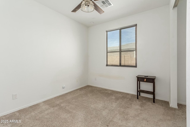 carpeted spare room featuring ceiling fan