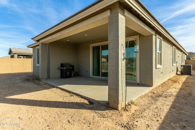 back of house with a patio and central AC