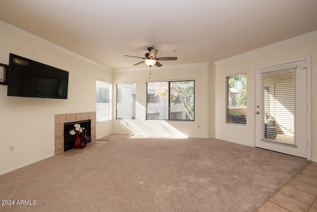 unfurnished living room featuring crown molding, light carpet, a fireplace, and ceiling fan