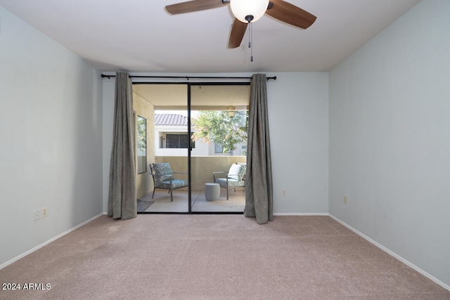 carpeted spare room with ceiling fan