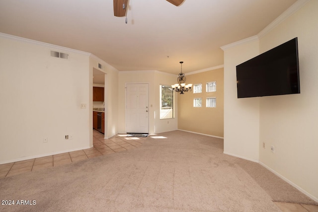 unfurnished living room with ceiling fan with notable chandelier, ornamental molding, and light colored carpet