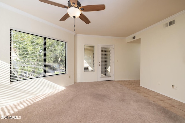 carpeted spare room with ornamental molding and ceiling fan