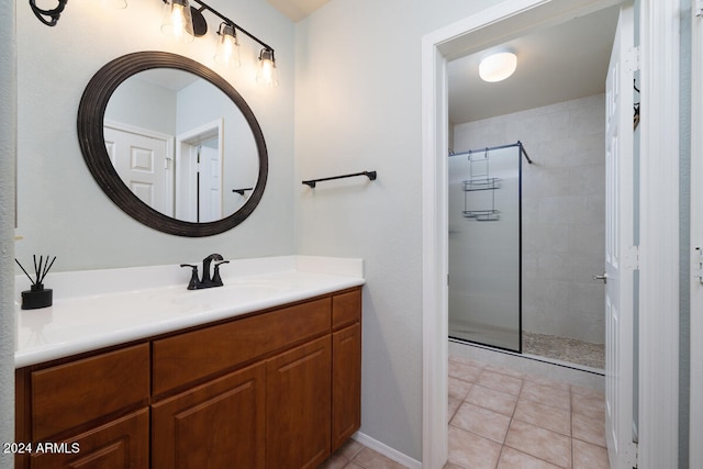 bathroom with vanity, a shower with shower door, and tile patterned flooring