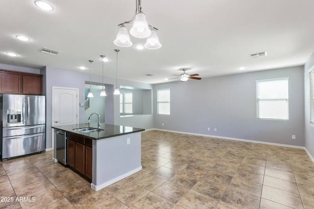 kitchen with decorative light fixtures, visible vents, stainless steel appliances, and a sink