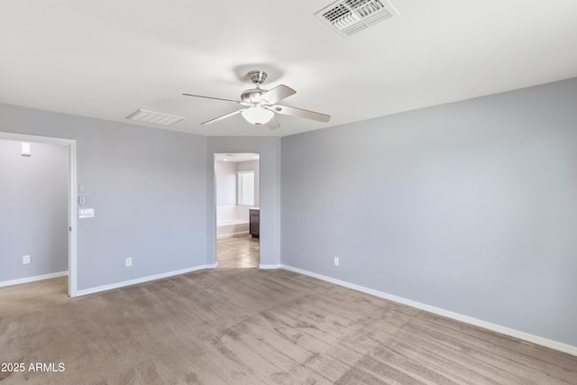 empty room featuring visible vents, baseboards, ceiling fan, and carpet floors