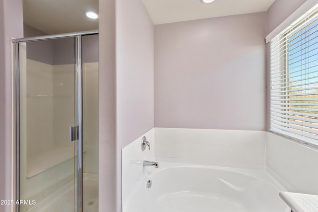 bathroom featuring recessed lighting, a garden tub, and a stall shower