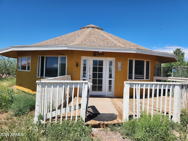 rear view of property featuring a wooden deck