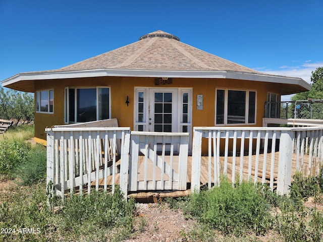 rear view of house featuring a wooden deck