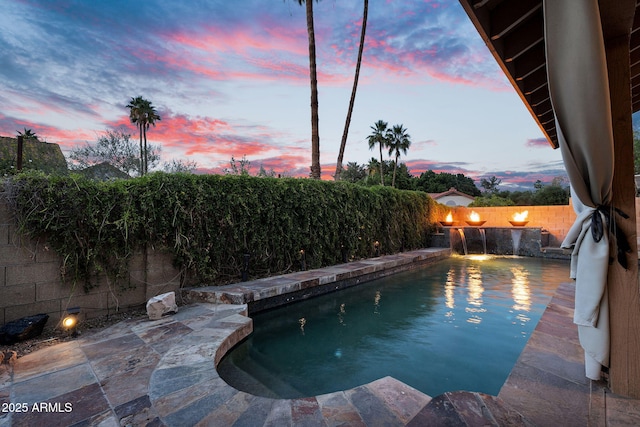 view of swimming pool featuring a fenced backyard and a patio