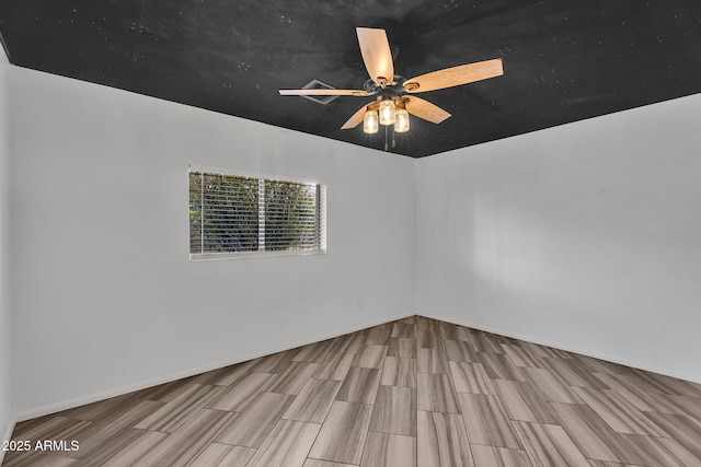 empty room with wood finished floors and a ceiling fan