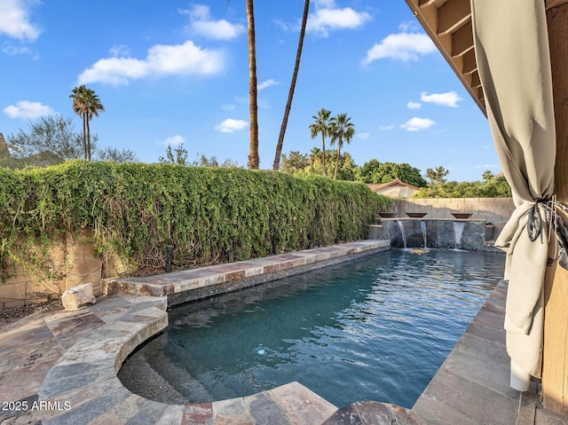 view of pool with a fenced backyard