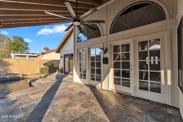 view of patio with french doors, fence, and a ceiling fan