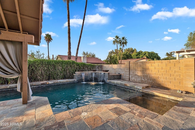 view of swimming pool with a fenced backyard