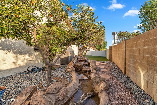 fenced backyard with central AC