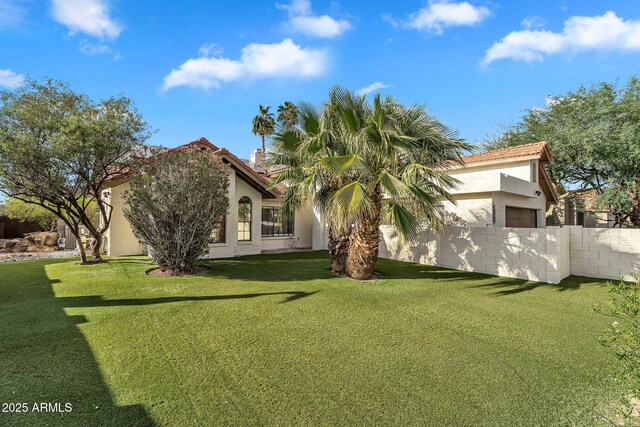 view of front of home with stucco siding, a tiled roof, and an attached garage