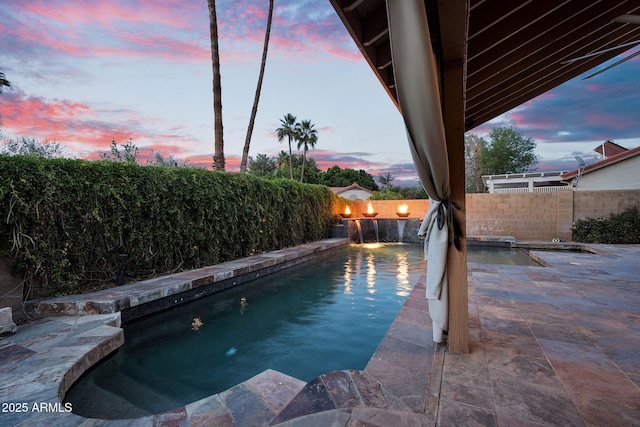 view of pool with a fenced backyard and a patio area