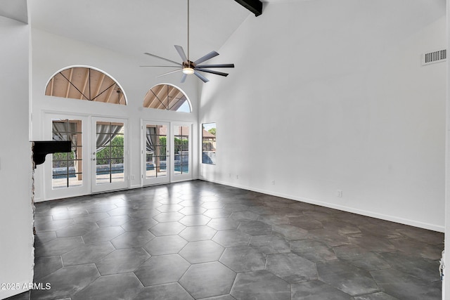 spare room with french doors, beamed ceiling, a ceiling fan, and high vaulted ceiling