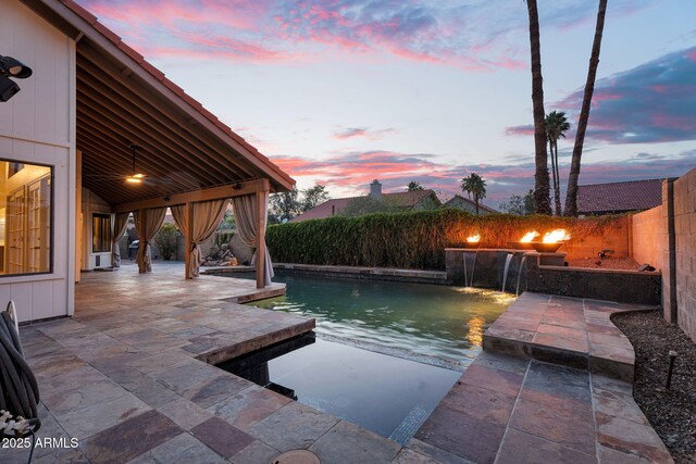 view of swimming pool with a patio and a fenced backyard