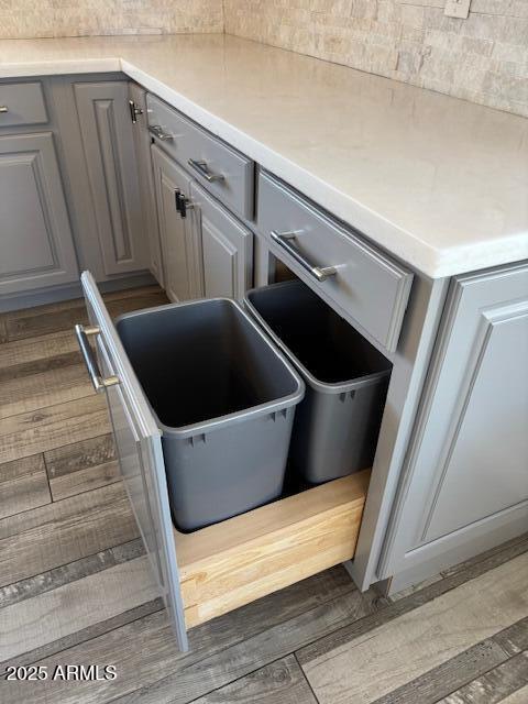 kitchen view of gray cabinetry, dark wood-type flooring, and light countertops