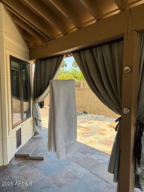 view of patio featuring fence