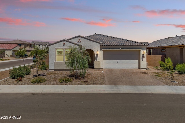 5430 W Notch Hill Rd, Laveen, AZ 85339 - mediterranean / spanish-style home with driveway, stucco siding, an attached garage, and a tile roof