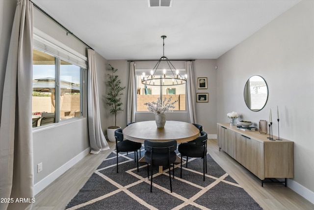 5430 W Notch Hill Rd, Laveen, AZ 85339 - dining area featuring a chandelier, baseboards, and light wood-type flooring