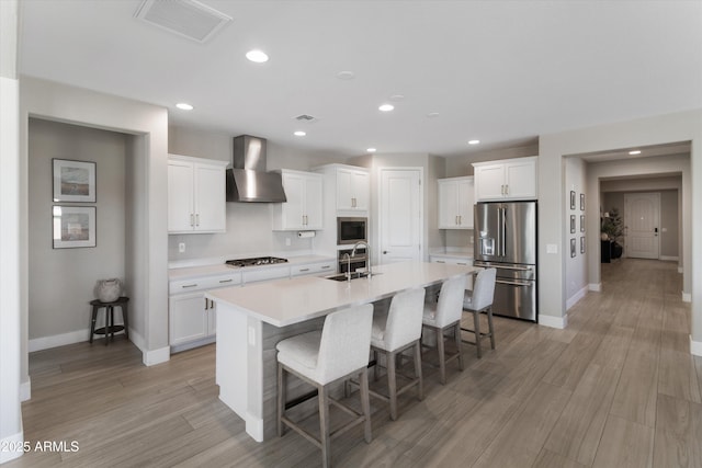 5430 W Notch Hill Rd, Laveen, AZ 85339 - kitchen with stainless steel appliances, wall chimney exhaust hood, a sink, baseboards, and recessed lighting