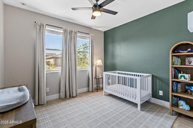 5430 W Notch Hill Rd, Laveen, AZ 85339 - bedroom with baseboards, a crib, and a ceiling fan