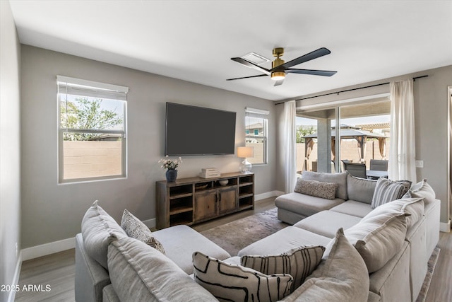 5430 W Notch Hill Rd, Laveen, AZ 85339 - living room featuring healthy amount of natural light, a ceiling fan, and baseboards