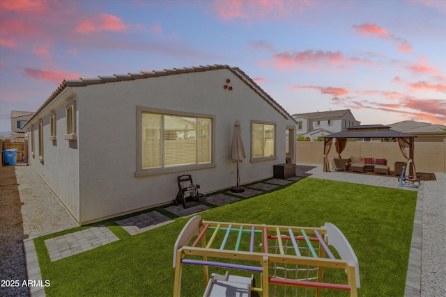 5430 W Notch Hill Rd, Laveen, AZ 85339 - back of house with a gazebo, outdoor lounge area, a patio, and stucco siding