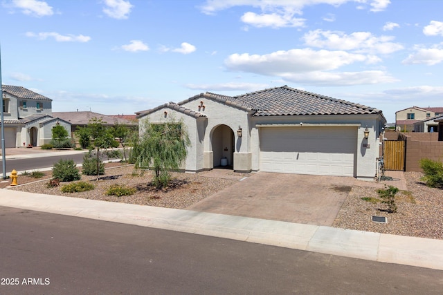 5430 W Notch Hill Rd, Laveen, AZ 85339 - mediterranean / spanish-style house featuring a tile roof, an attached garage, driveway, and stucco siding