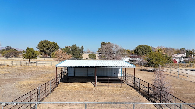 view of horse barn with a rural view