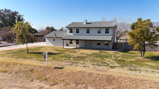 view of front of house featuring a front yard and a patio area