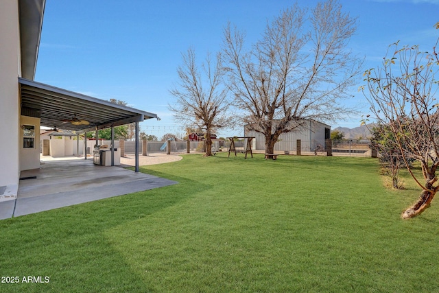 view of yard featuring ceiling fan and a patio area